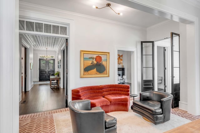 living room featuring crown molding and a chandelier