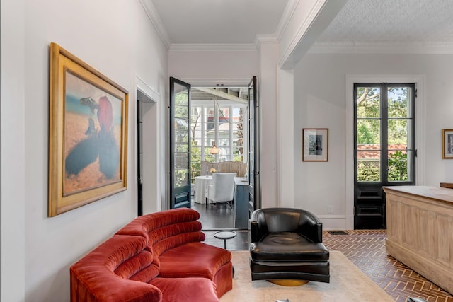 sitting room featuring dark parquet flooring, crown molding, plenty of natural light, and french doors