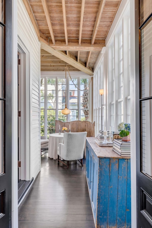 unfurnished sunroom with vaulted ceiling with beams, breakfast area, and wooden ceiling