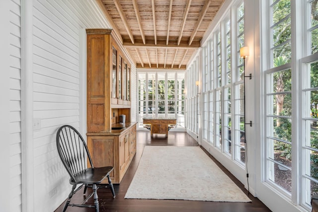 sunroom with a healthy amount of sunlight, beamed ceiling, and wooden ceiling