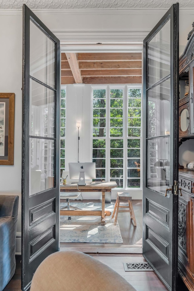 entryway featuring crown molding and hardwood / wood-style floors