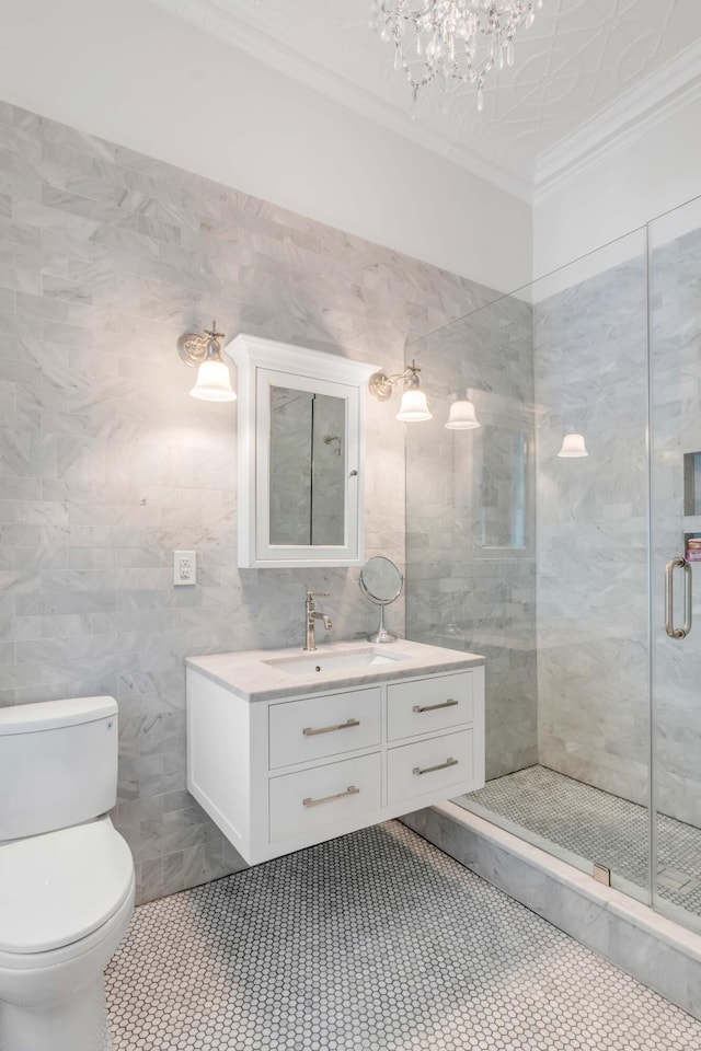 bathroom featuring walk in shower, toilet, vanity, tile walls, and ornamental molding