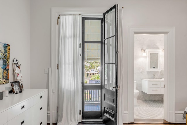 doorway to outside featuring sink