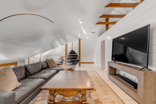 living room with lofted ceiling with beams and light hardwood / wood-style floors