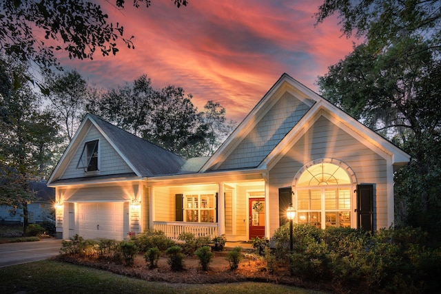 view of front of house featuring covered porch and a garage