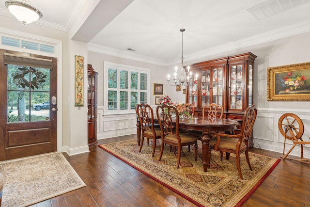 dining area featuring an inviting chandelier, crown molding, a wealth of natural light, and dark wood-type flooring