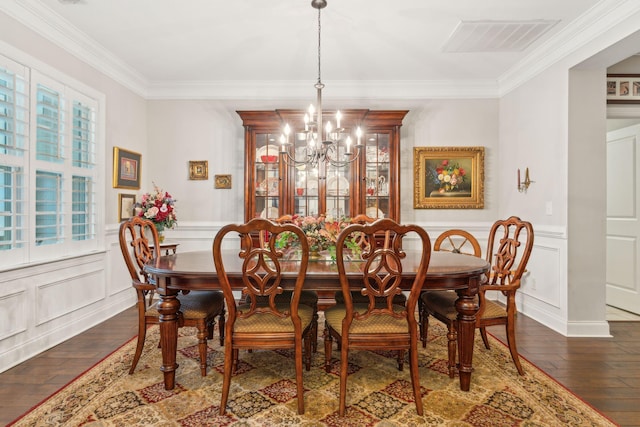 dining area with crown molding, dark hardwood / wood-style flooring, and a chandelier