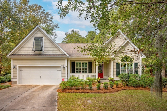 view of front of property with a front lawn, a porch, and a garage