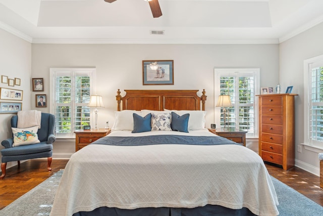 bedroom with ceiling fan, ornamental molding, and dark wood-type flooring