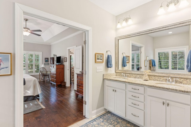 bathroom featuring vanity, hardwood / wood-style flooring, ceiling fan, and crown molding