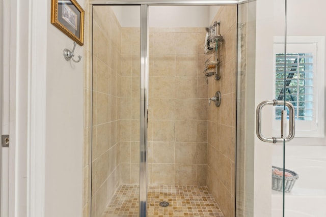 bathroom with a shower with door