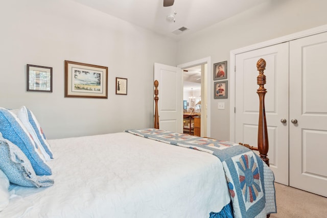 bedroom featuring ceiling fan, light colored carpet, and a closet