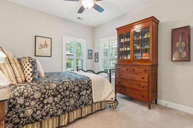 bedroom with ceiling fan and light colored carpet