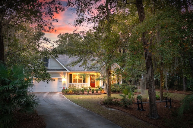 view of front of property featuring covered porch and a garage