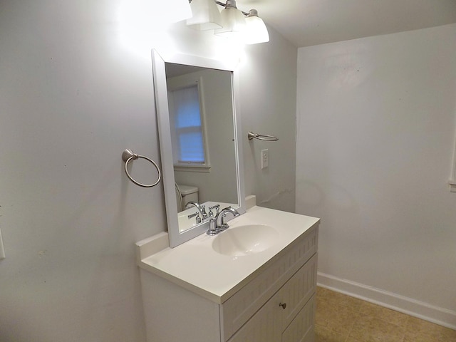 bathroom featuring vanity, tile patterned floors, and toilet