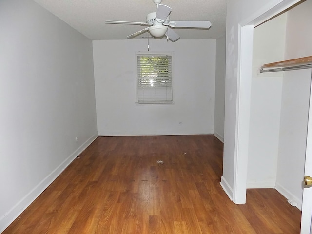 unfurnished bedroom featuring a textured ceiling, hardwood / wood-style floors, ceiling fan, and a closet