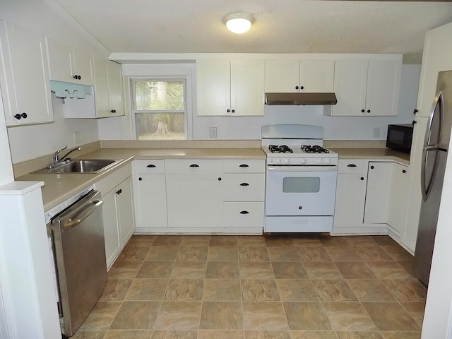 kitchen featuring white cabinets, appliances with stainless steel finishes, and sink