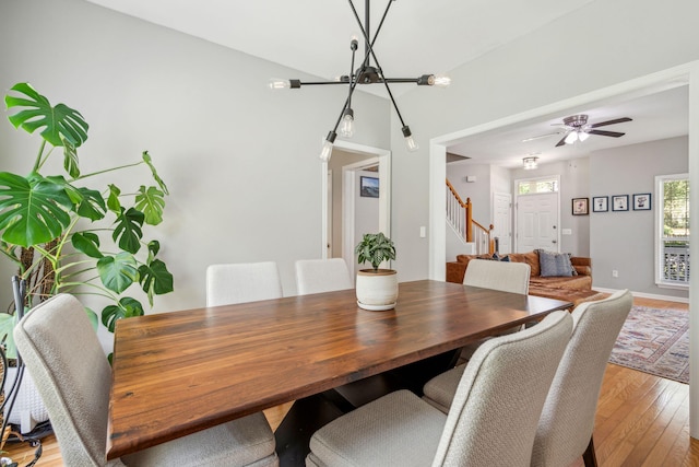 334 Mossy Oak Way, Mount Pleasant, SC 29464 - dining room with a chandelier, stairs, light wood-style floors, and baseboards