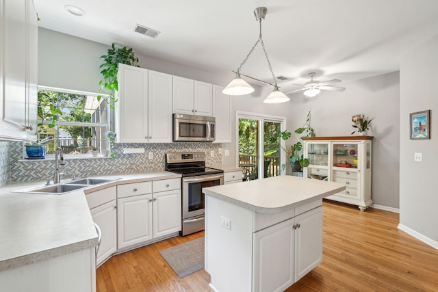 334 Mossy Oak Way, Mount Pleasant, SC 29464 - kitchen with stainless steel appliances, tasteful backsplash, a sink, and white cabinetry