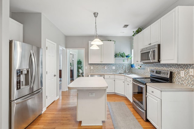 334 Mossy Oak Way, Mount Pleasant, SC 29464 - kitchen with appliances with stainless steel finishes, light countertops, a center island, white cabinets, and a sink