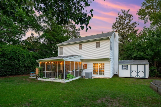 334 Mossy Oak Way, Mount Pleasant, SC 29464 - back of house at dusk with a chimney, cooling unit, a lawn, and a sunroom