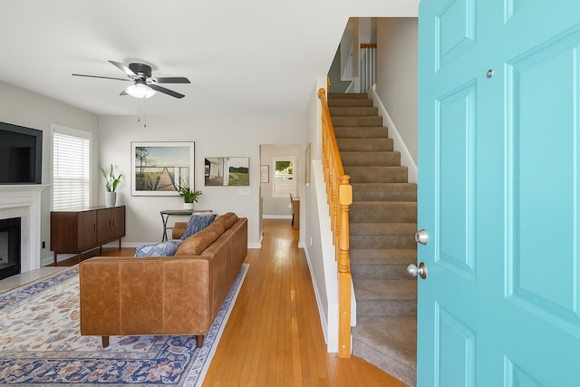334 Mossy Oak Way, Mount Pleasant, SC 29464 - living room with stairway, ceiling fan, light wood-style floors, baseboards, and a glass covered fireplace