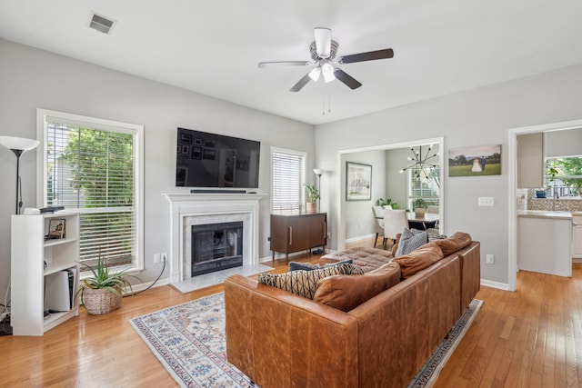 334 Mossy Oak Way, Mount Pleasant, SC 29464 - living room with a ceiling fan, light wood-type flooring, a fireplace, and baseboards