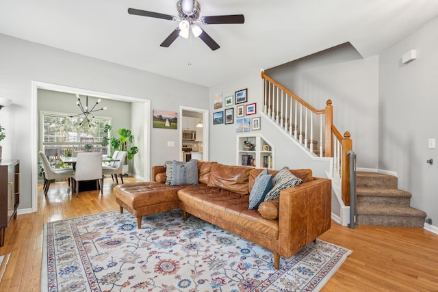 334 Mossy Oak Way, Mount Pleasant, SC 29464 - living area with stairs, light wood-type flooring, ceiling fan, a chandelier, and baseboards