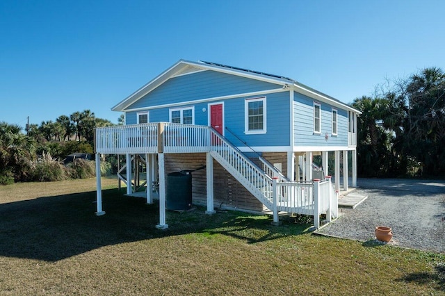 coastal inspired home with a front lawn