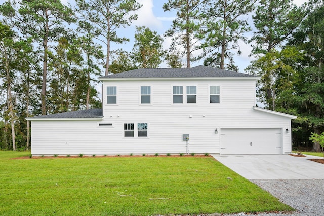 exterior space featuring a lawn and a garage