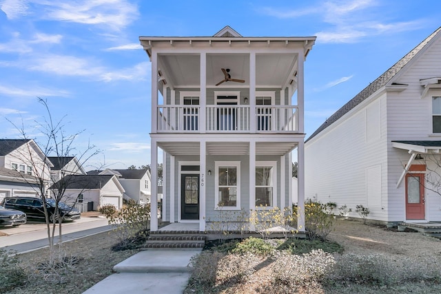 view of front facade featuring a porch, a balcony, and a ceiling fan