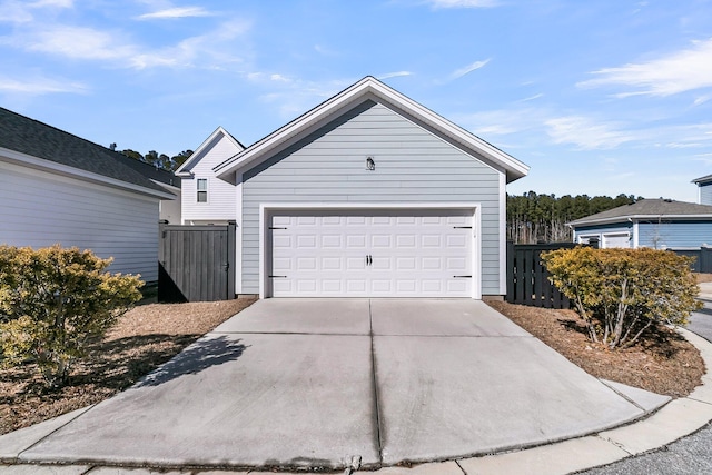 view of front facade with a garage, an outbuilding, and fence