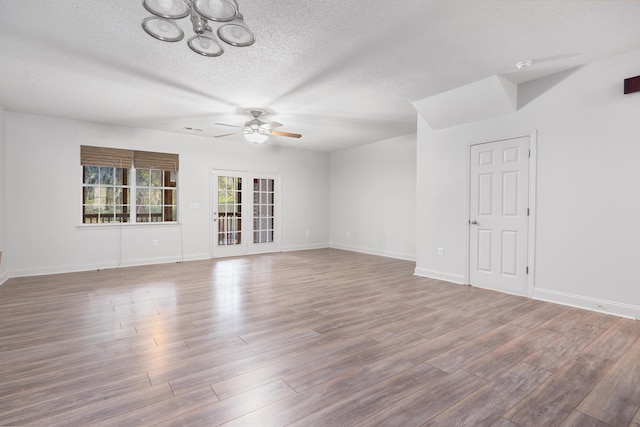 unfurnished room featuring ceiling fan, wood-type flooring, and a textured ceiling