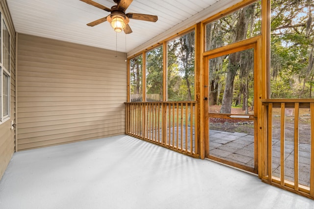 unfurnished sunroom with ceiling fan and wooden ceiling