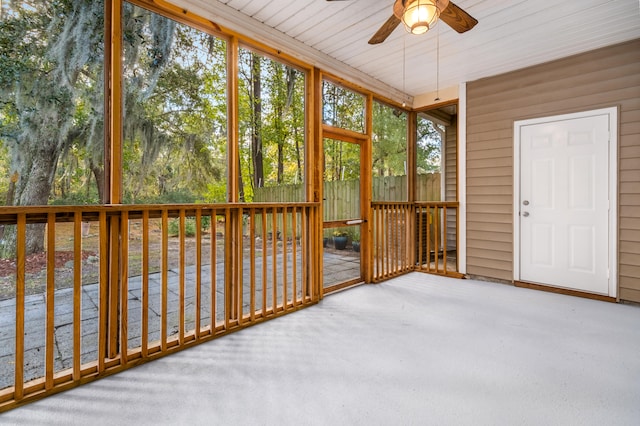 unfurnished sunroom with ceiling fan and wood ceiling