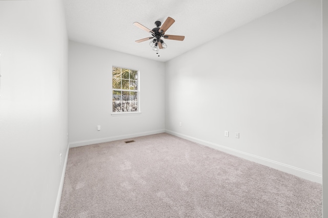 unfurnished room featuring carpet and ceiling fan