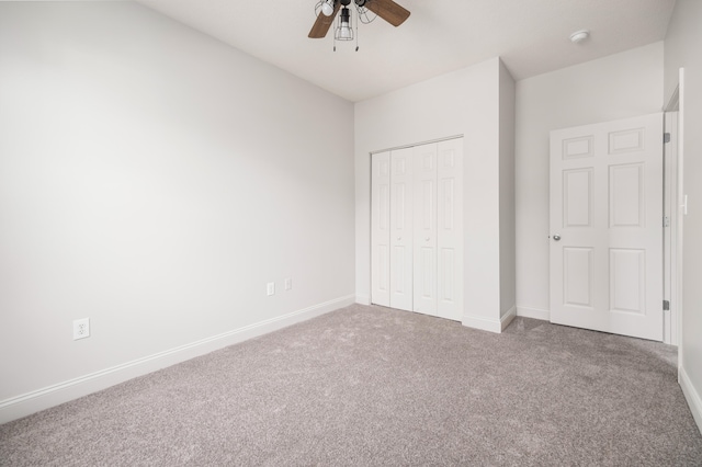 unfurnished bedroom with carpet, a closet, and ceiling fan