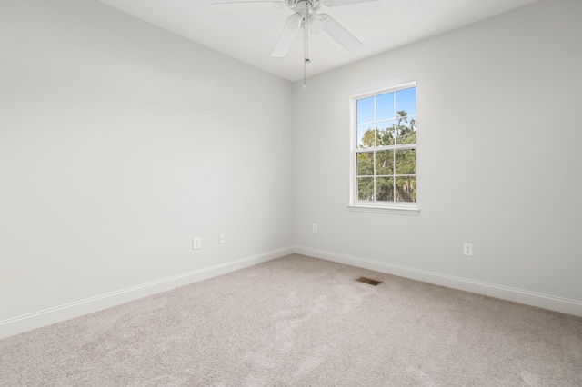 carpeted spare room with ceiling fan