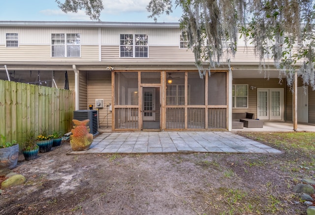 rear view of house featuring french doors, a patio, central AC, and a sunroom