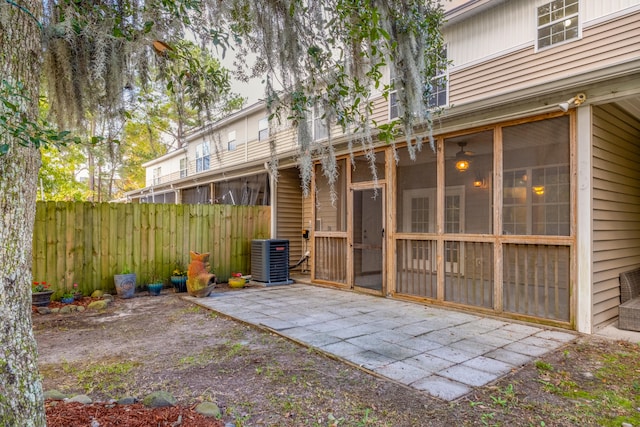 exterior space featuring cooling unit, a patio area, and a sunroom