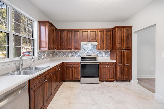 kitchen with tasteful backsplash, sink, and stainless steel appliances