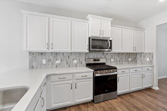 525 Purple Finch Rd, Summerville, SC 29486 - kitchen with appliances with stainless steel finishes, wood finished floors, white cabinets, tasteful backsplash, and light countertops