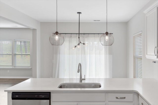 525 Purple Finch Rd, Summerville, SC 29486 - kitchen with stainless steel dishwasher, a sink, white cabinets, and light countertops
