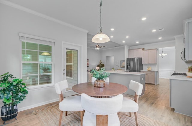 dining space with light wood-type flooring, ornamental molding, recessed lighting, ceiling fan, and baseboards
