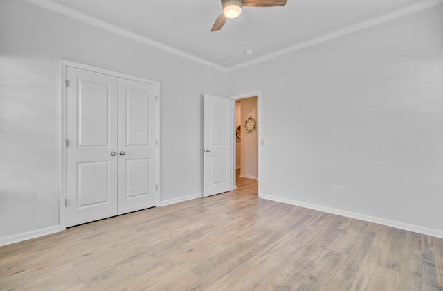 unfurnished bedroom with crown molding, light wood finished floors, and baseboards