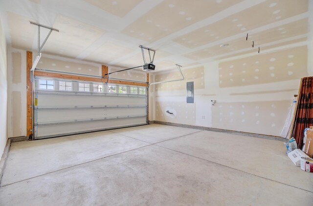 garage with a garage door opener and electric panel