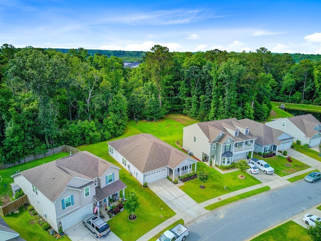 aerial view of residential area with a heavily wooded area