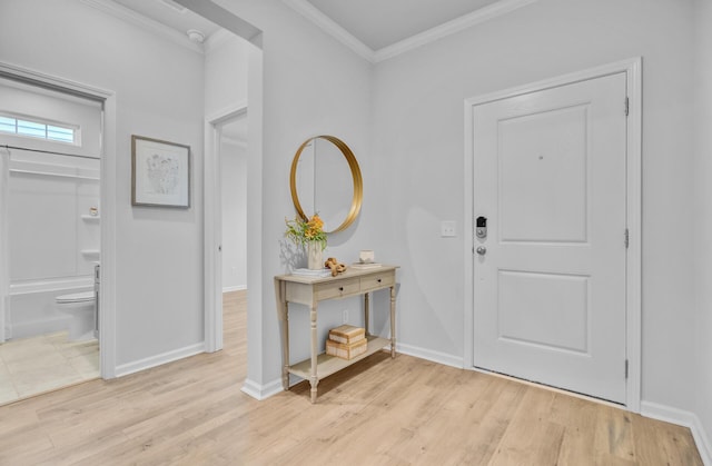 entryway featuring crown molding, wood finished floors, and baseboards