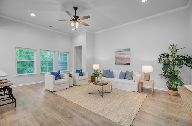 living room with baseboards, light wood-style floors, ceiling fan, ornamental molding, and recessed lighting