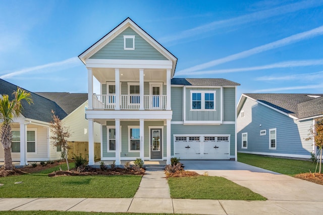 view of front of home with covered porch, a balcony, a garage, and a front lawn